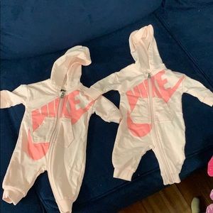 Two Nike pink onesies